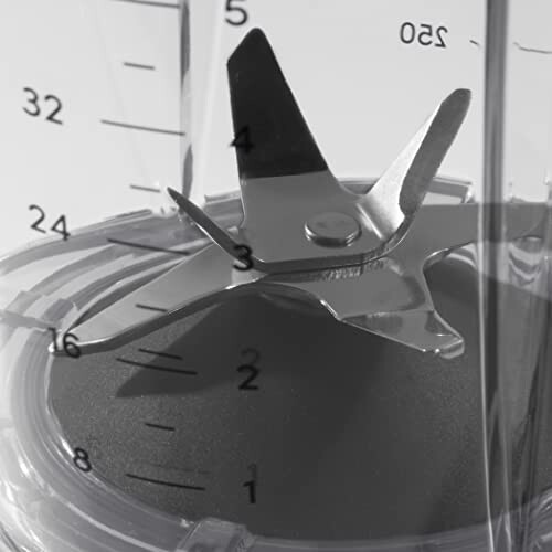 Close-up of blender blades inside a container with measurement markings.