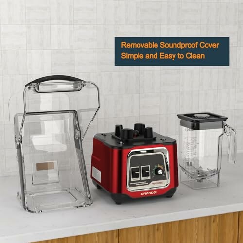 Blender with removable soundproof cover and pitcher on a counter.