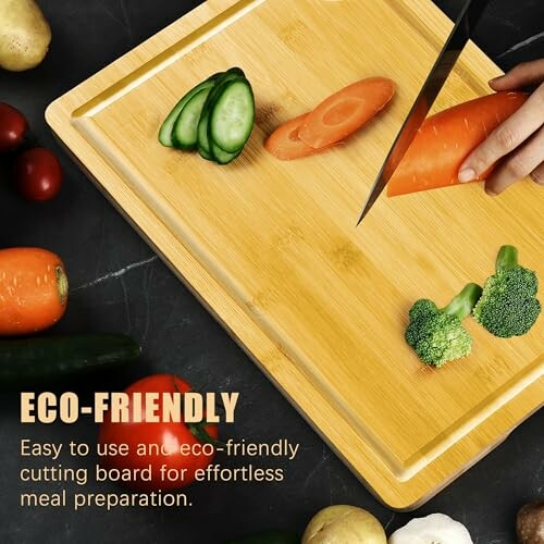 Person slicing vegetables on an eco-friendly bamboo cutting board.