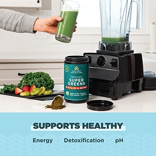 Person blending organic super greens with vegetables and powder container nearby.