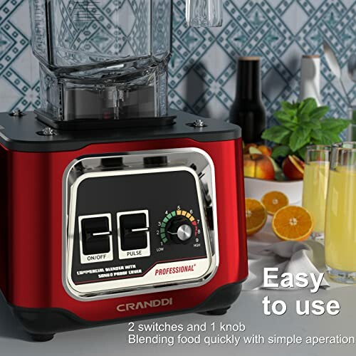 Red blender with control panel, fruit slices, and orange juice on counter.